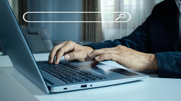 Photo mans hands are using a computer notebook to searching for information