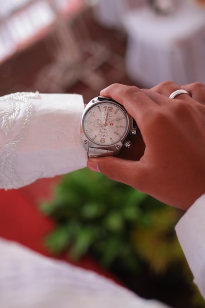 Mans watch on hand Wedding ceremony