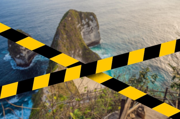 Manta bay or kelingking beach on nusa penida island bali indonesia covid quarantine yellow tape