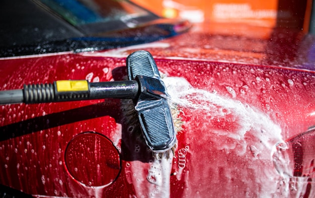 manual car wash with foam brush red body