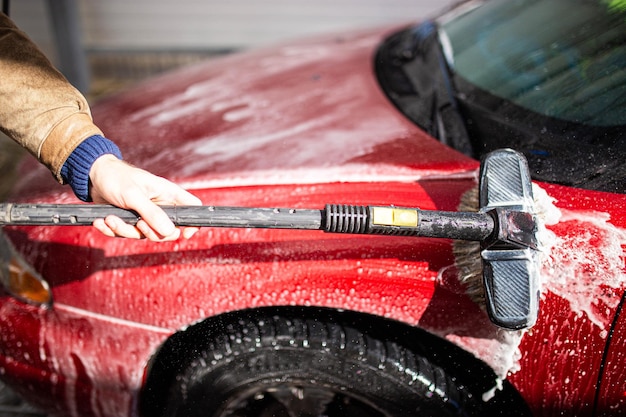 manual car wash with foam brush red body