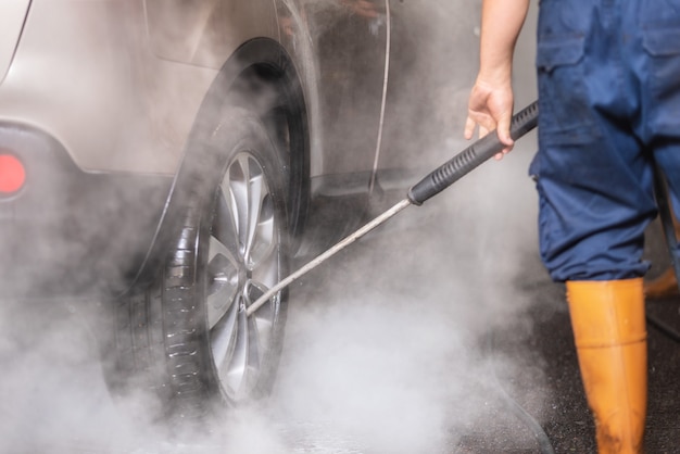 Manual car wash with pressurized water in car wash outside.