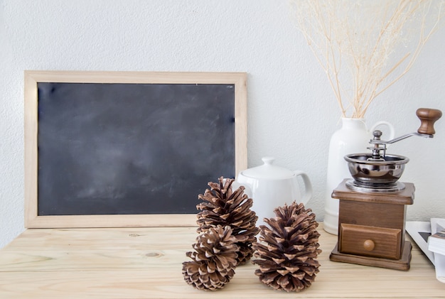 manual coffee grinder and pine cone in coffee shop