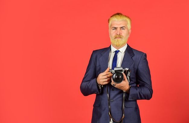 Manual settings. Photographer with blond beard and mustache. Content creator. Man bearded hipster photographer. Photographer hold retro camera. Connoisseur of vintage values. Classy and old school.