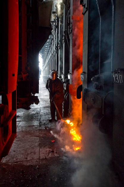 Photo manual worker molting iron in factory