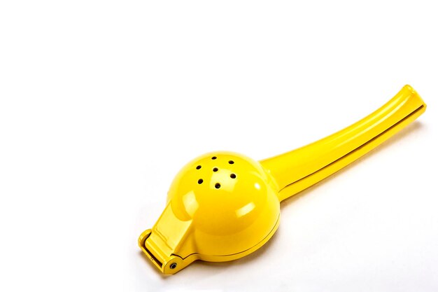 Manual yellow lemon squeezer white background Horizontal view of lemon squeezer space for text