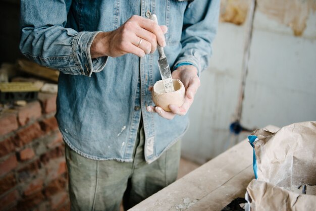 Photo manually mixing gypsum and water