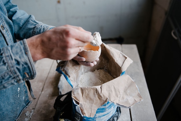 Photo manually mixing gypsum and water