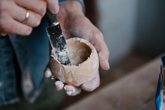 Manually mixing gypsum and water