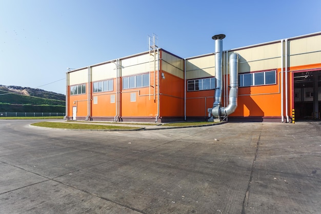 Manufacture building of modern waste recycling processing plant in orange style Separate garbage collection Recycling and storage of waste for further disposal