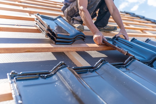 Manufacture of the roof of a family house from ceramic tiles. copy space