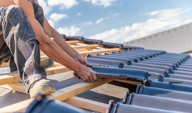 Photo manufacture of the roof of a family house from ceramic tiles. copy space