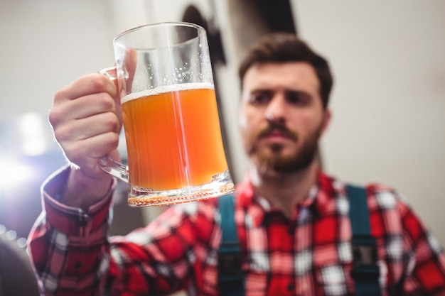 Manufacturer holding beer in jug