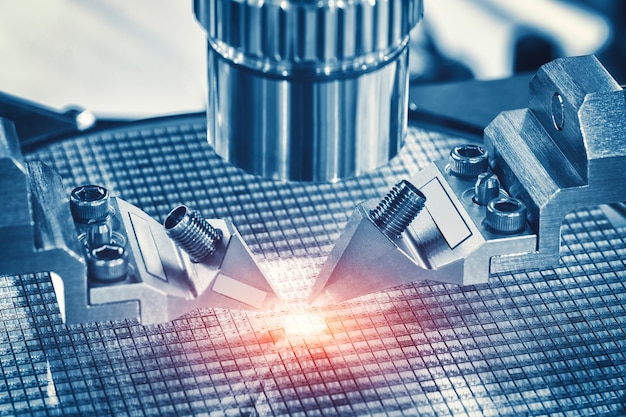 Manufacturing of microchips with close up of examining of test sample of microchip transistor under the microscope in laboratory.