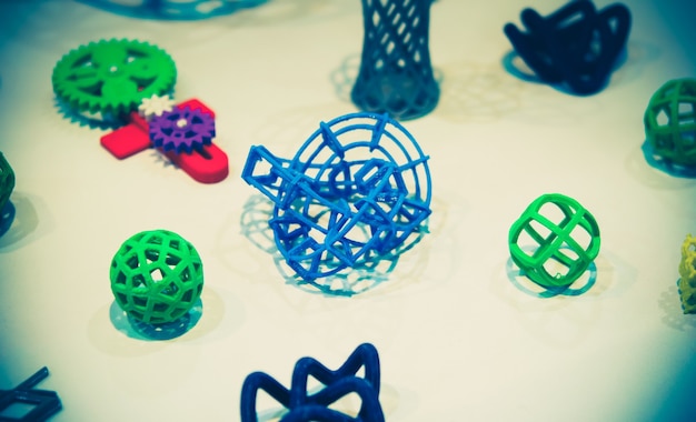 Many abstract models printed by 3d printer close-up.