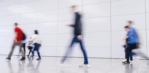 Many anonymous business people go to a business trade fair