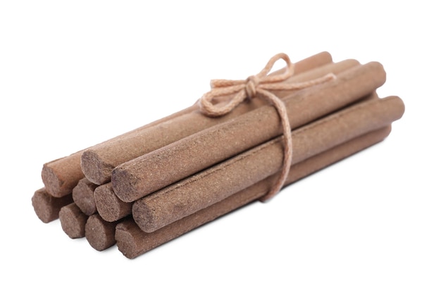 Many aromatic incense sticks tied with twine on white background