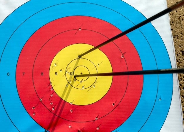 Many arrows hitting the archery target bulls eye