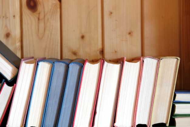 Many assorted old books casually lays in pile front view close up