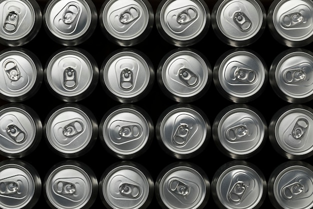 Many beer cans seen from above closeup full frame as background