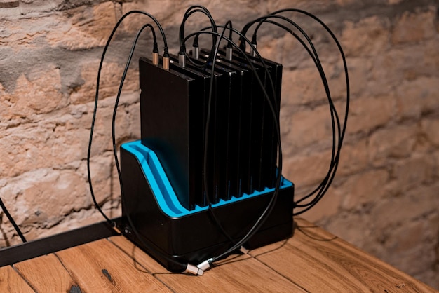 Many big portable phone chargers for charging phones stands\
inside a dock station on the table at restaurant. portable. useful.\
electric. electricity. useful. modern. gadget. tool. battery\
charger