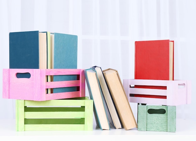 Photo many books in crates on light background