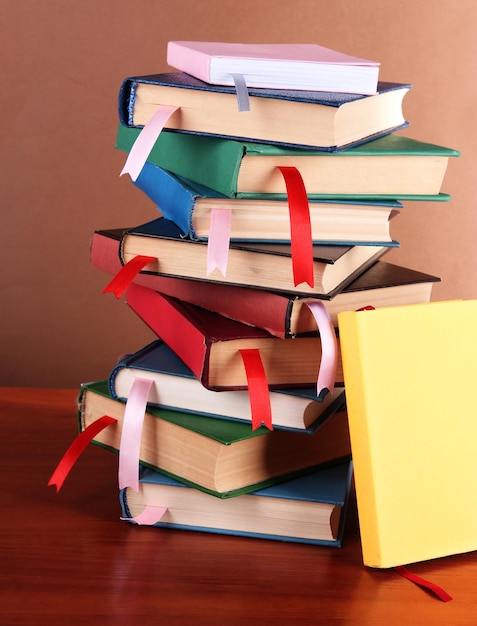 Many books with bookmarks on brown background