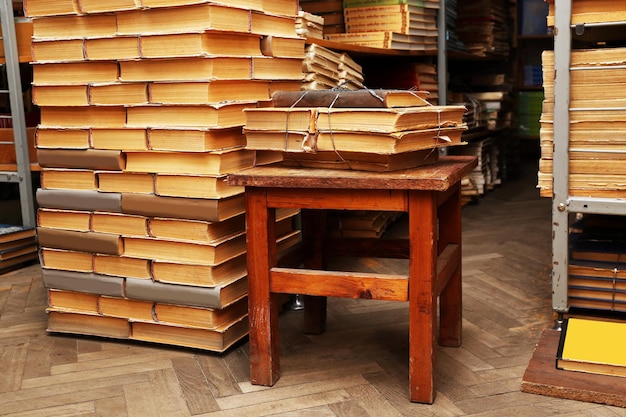 Many books on wooden chair in library