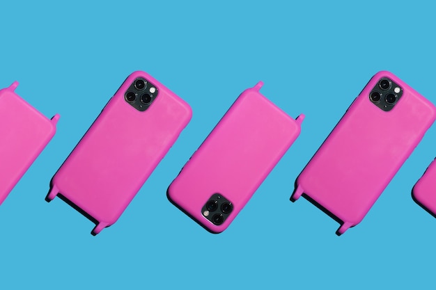 Many bright pink phones on a blue background