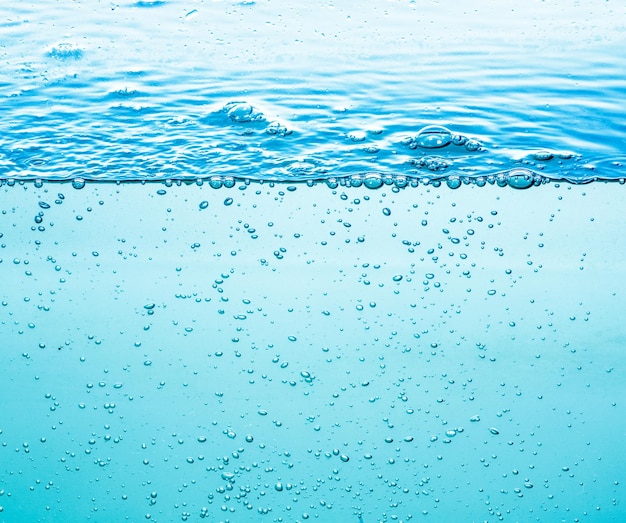 水中の多くの泡がクローズアップ、泡で抽象的な水の波