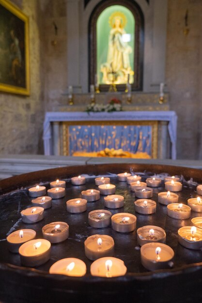 Many burning candles in church Selective focus High quality photo