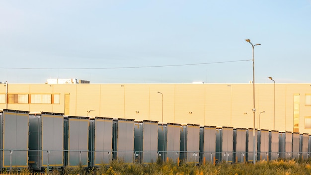 Many cargo trailers are parked near the logistics warehouse waiting to be loaded and unloaded