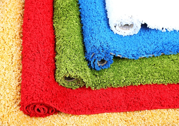 Many carpets of different colors closeup