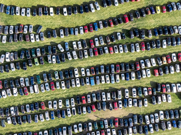 Many cars parked in the field.