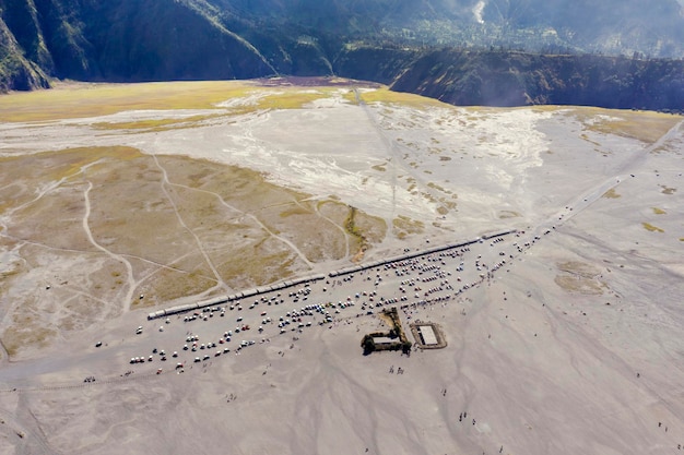 Many cars parked on foothills Bromo mountain