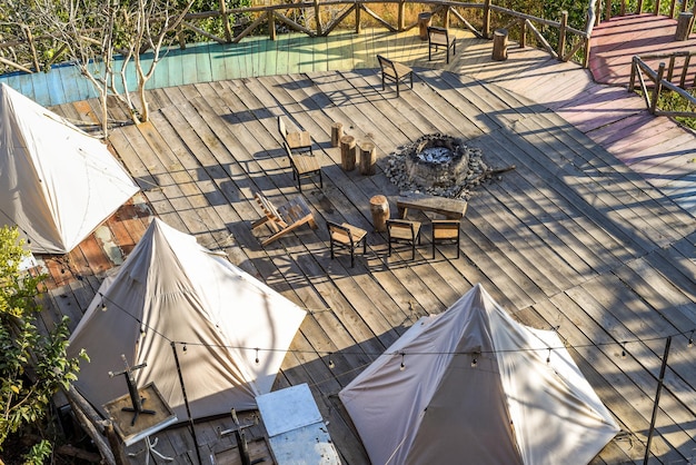 Many chairs and fire place near tents in camping in Da Lat Vietnam