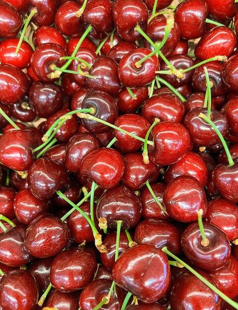 Many cherries seen up close vertical photo