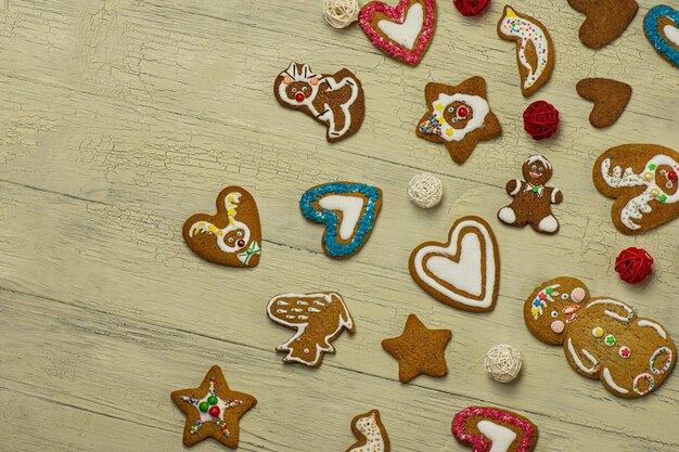 Many Christmas cookies on white wooden table