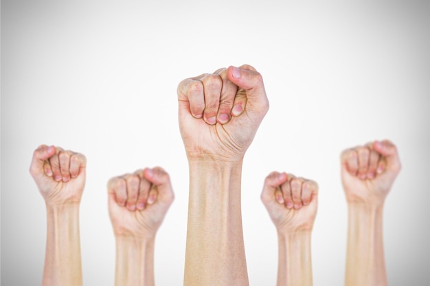 Photo many clenched fists punch air energetically on gray background together we stand