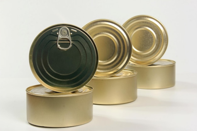 Many closed tin cans on white background. metal cans for fish and meat products