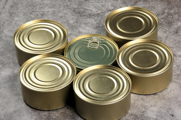 Many closed tin cans on white background. metal cans for fish and meat products