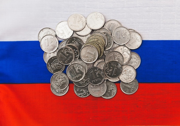 Many coins of 1 ruble lie on Russian money