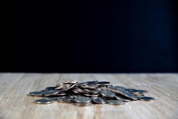 Many coins are stacked in a graph on the table. For financial planning and saving concepts