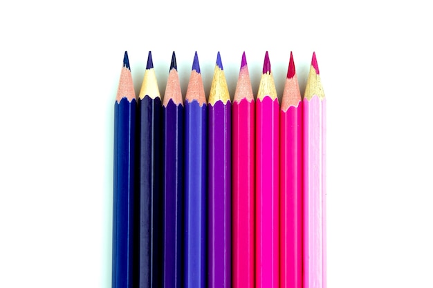 Many color pencils on white isolated background. close-up. top view. stationery.