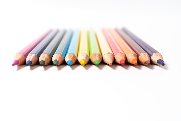 Many colored pencils on white background