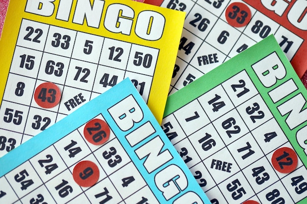 Many colorful bingo boards or playing cards for winning chips Classic US or canadian five to five bingo cards on bright background