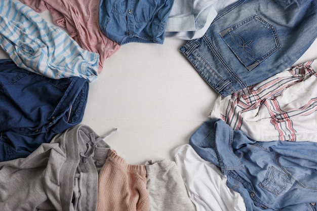 Many colorful clothes are lying on the floor. The view from the top.