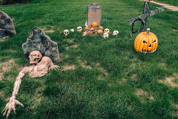 Photo many colorful halloween decorations skeletons scarecrows at driveway and front lawn of house