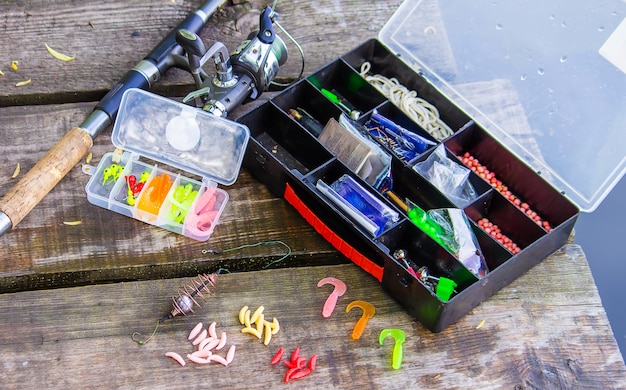 Many colorful lures for fishing on the wooden pier