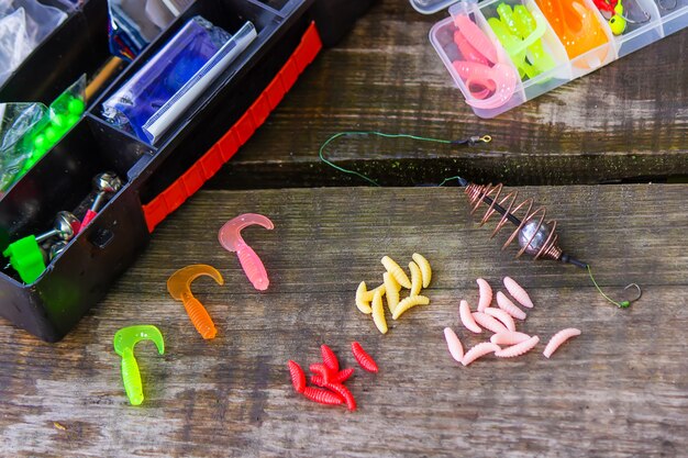 Photo many colorful lures for fishing on the wooden pier